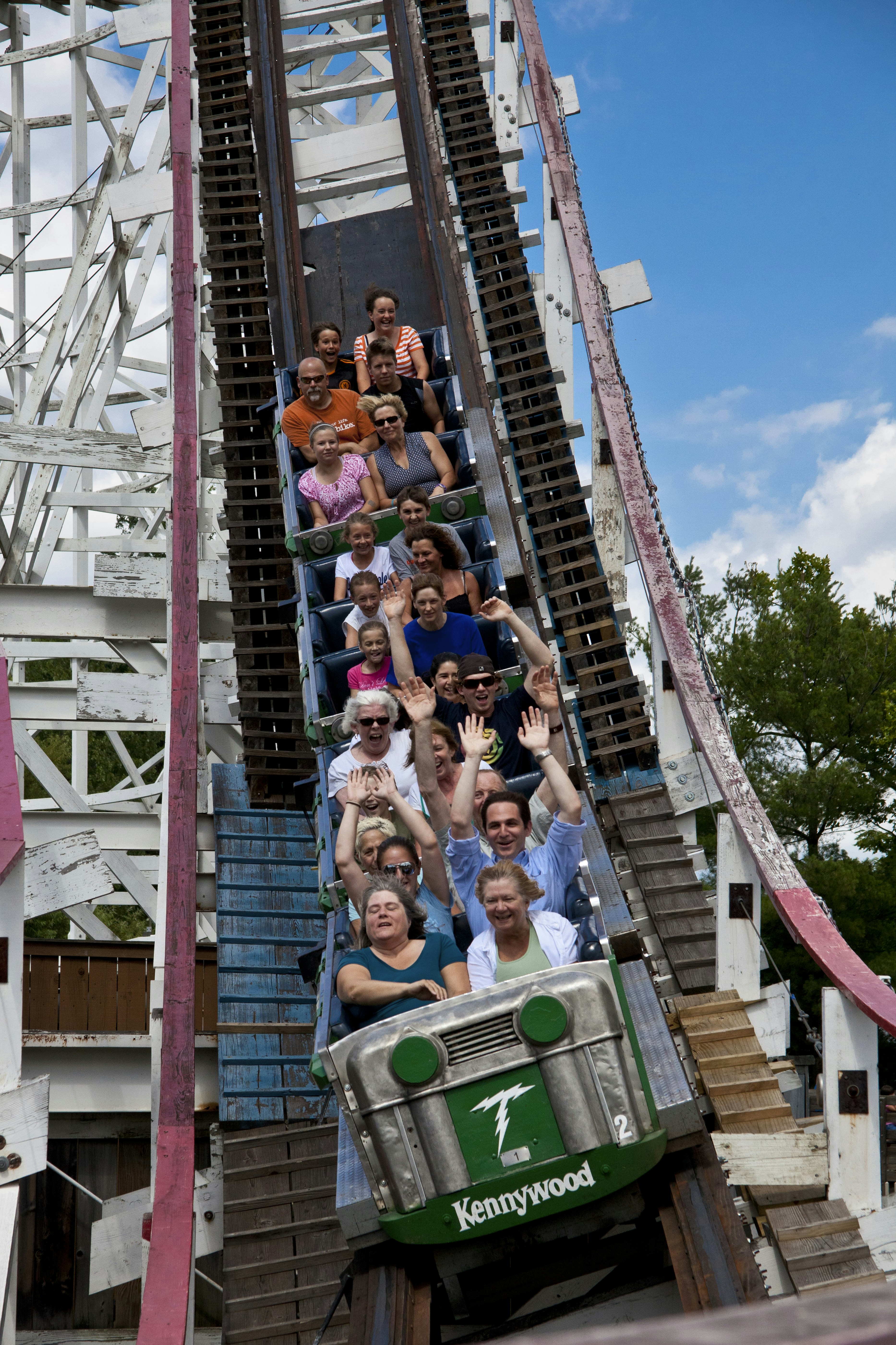 A group of people scream on a wooden roller coaster at Kennywood Amusement Park in Pittsburgh