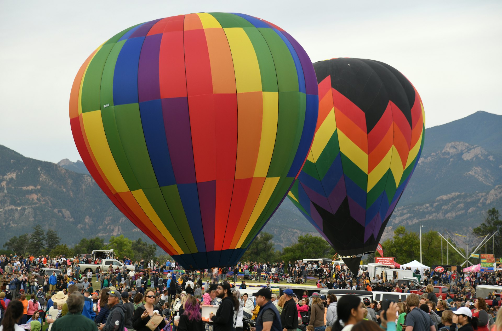 Hot air balloons in a crowded Memorial Park in Colorado Springs at Labor Day Lift Off