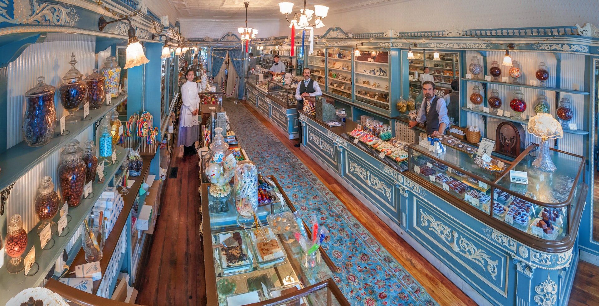 Staff members work in Shane Confectionery in Philadelphia, with an old-style blue and white interior