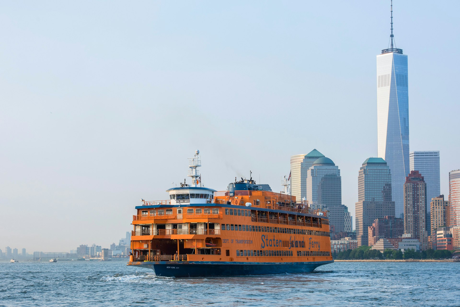 The Staten Island Ferry as seen from the water, with the Manhattan skyline in the background