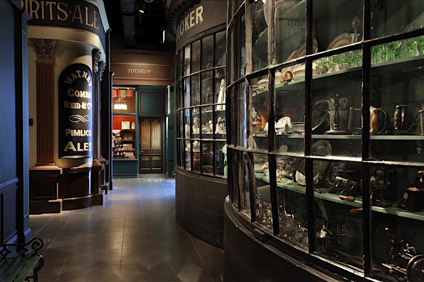 Victorian Walk © Museum of London A mock-up of a dark cobbled alleyway in a museum with several authentic shopfronts
