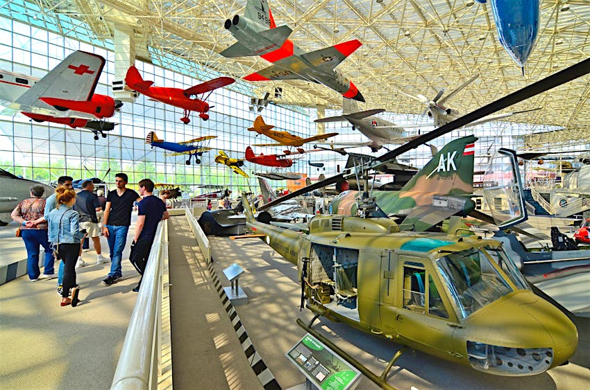 Planes and a helicopter on display inside the Seattle Museum of Flight