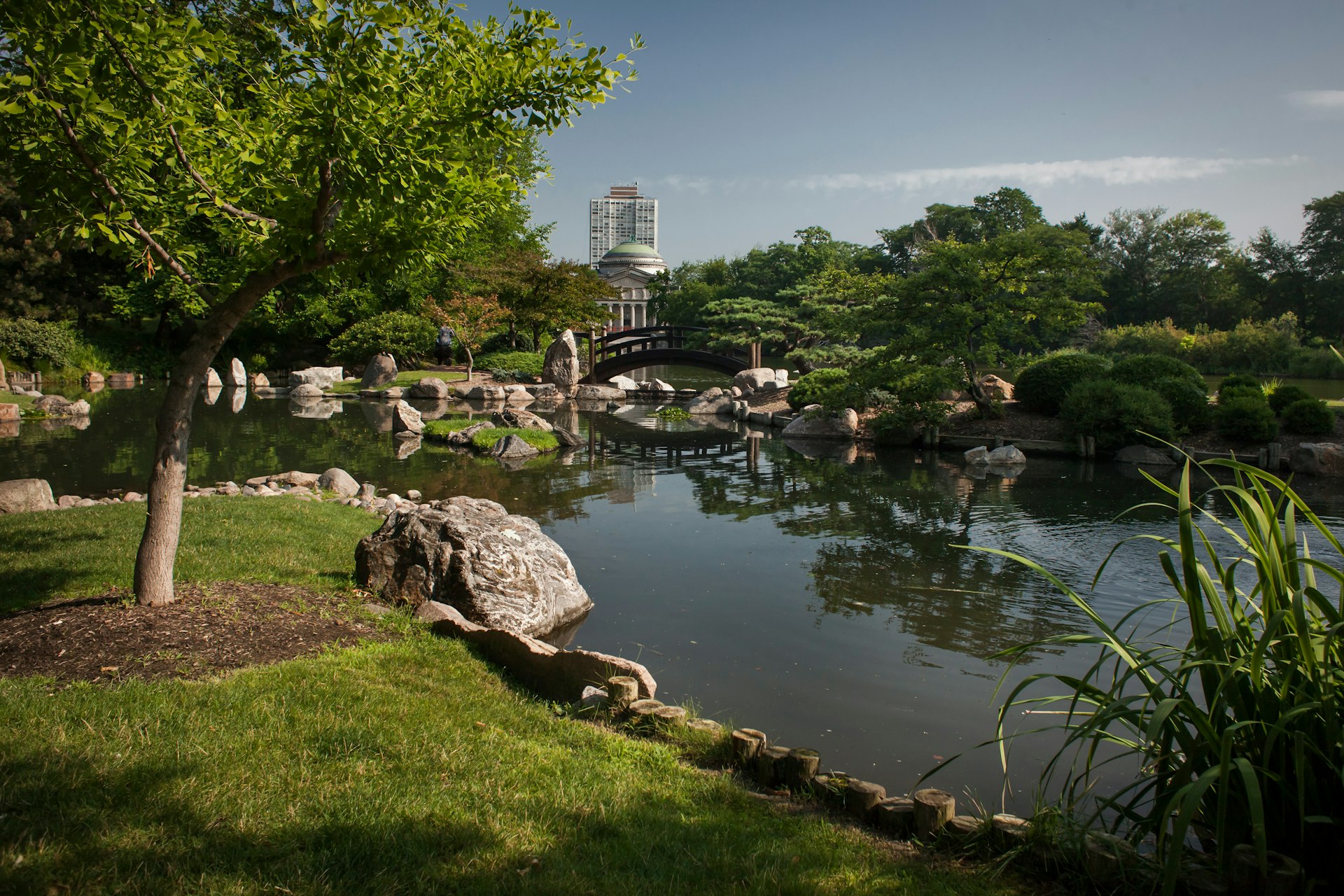 The Osaka Japanese Garden (Garden of the Phoenix), with the Museum of Science & Industry in the background.
