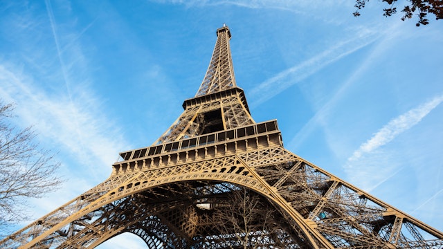 Wide shot of Eiffel Tower with blue sky, Paris, France.