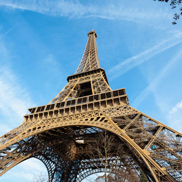 Wide shot of Eiffel Tower with blue sky, Paris, France.