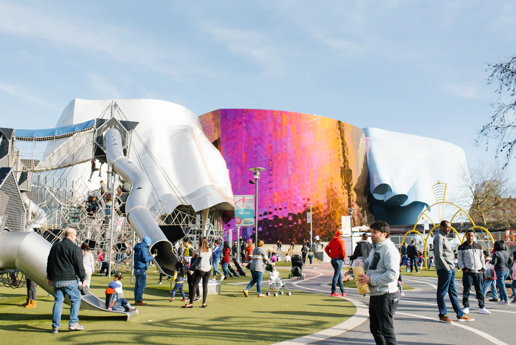 Visitors outside the Museum of Pop Culture and a children's playground
