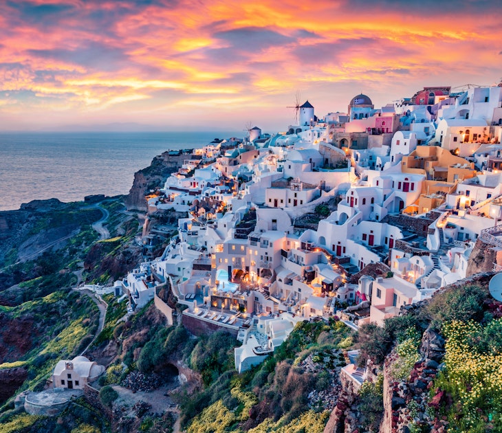 Summer sunset over the Greek town of Oia and the Mediterranean Sea.
