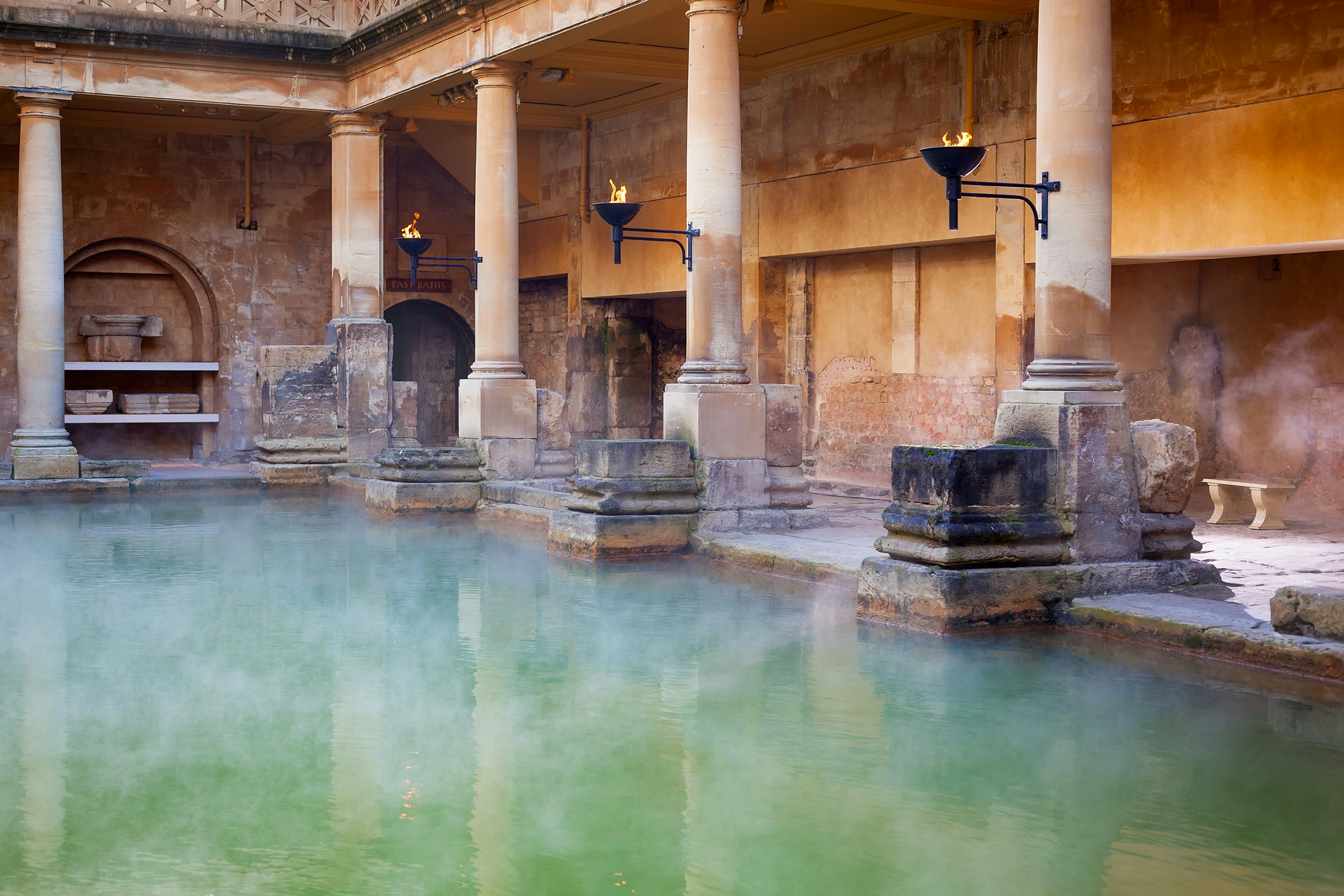 Steam rising off the hot mineral water in the Great Bath, part of the Roman Baths in Bath