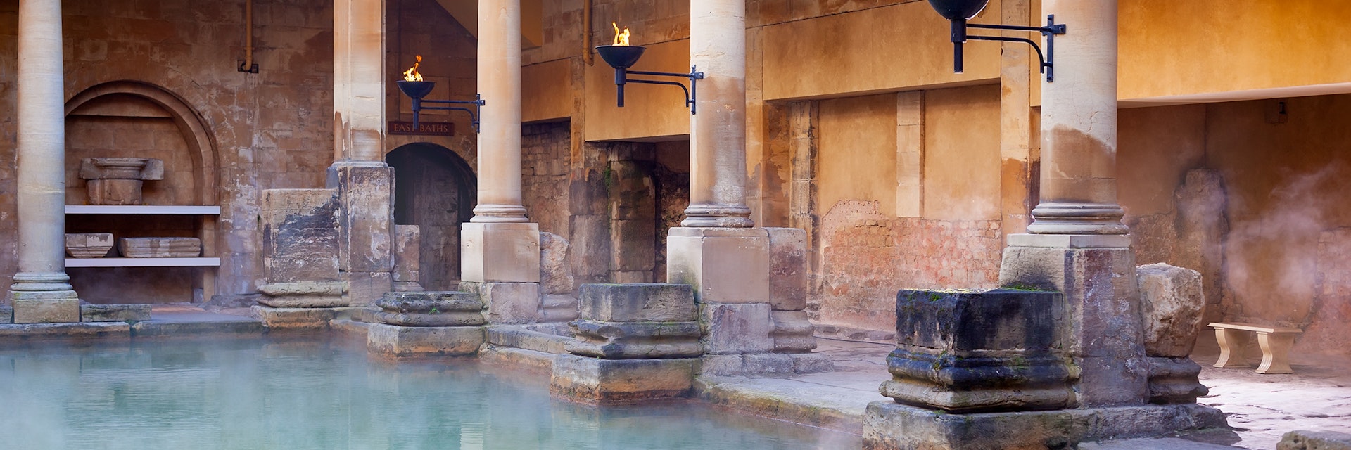 Steam rising off the hot  mineral water in the Great Bath, part of the Roman Baths in Bath, UK