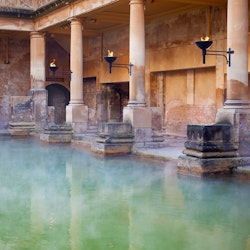 Steam rising off the hot mineral water in the Great Bath, part of the Roman Baths in Bath, UK