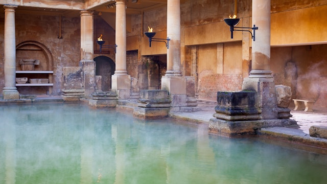 Steam rising off the hot  mineral water in the Great Bath, part of the Roman Baths in Bath, UK