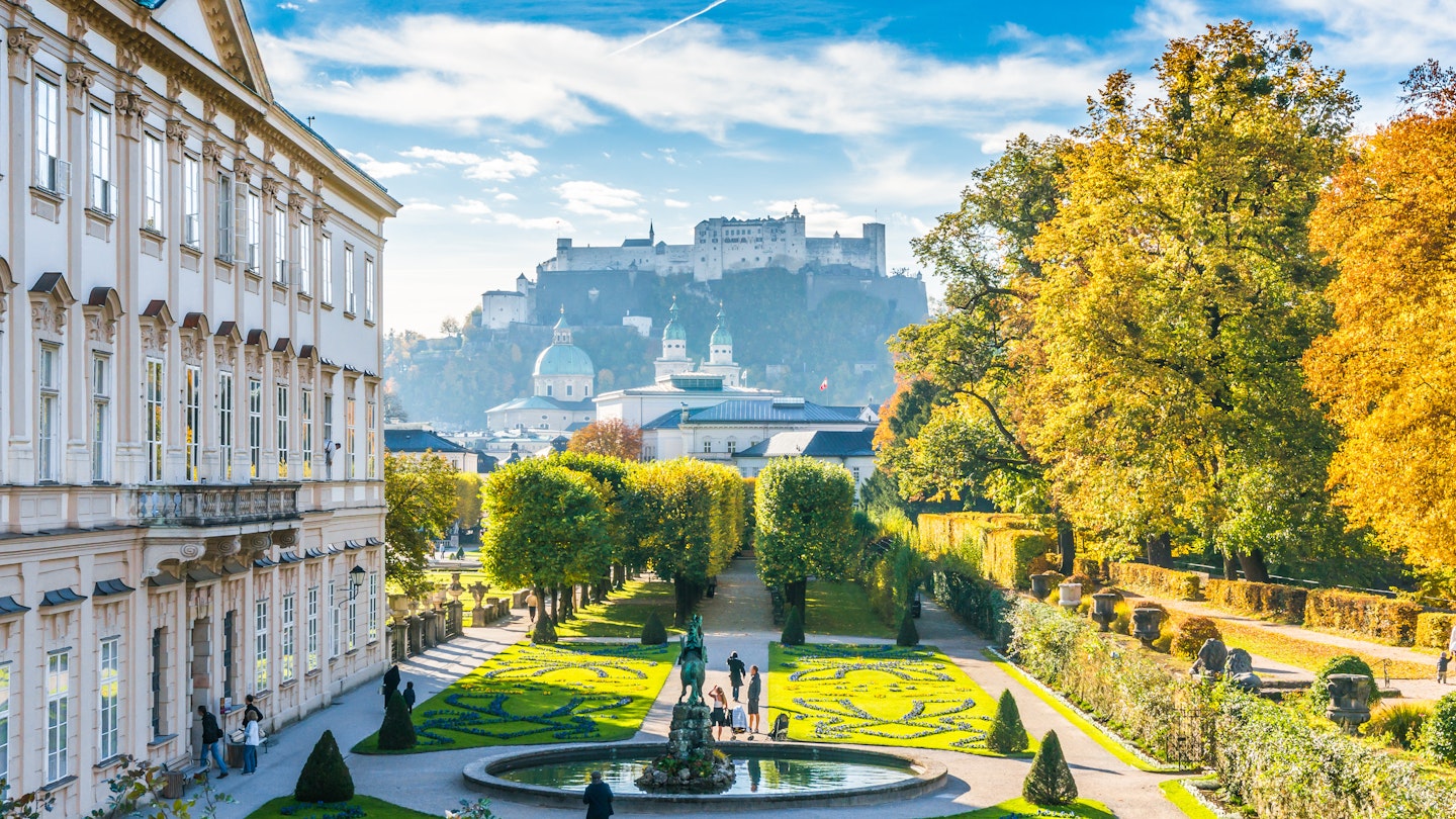 Beautiful view of famous Mirabell Gardens with the old historic Fortress Hohensalzburg in the background in Salzburg, Austria