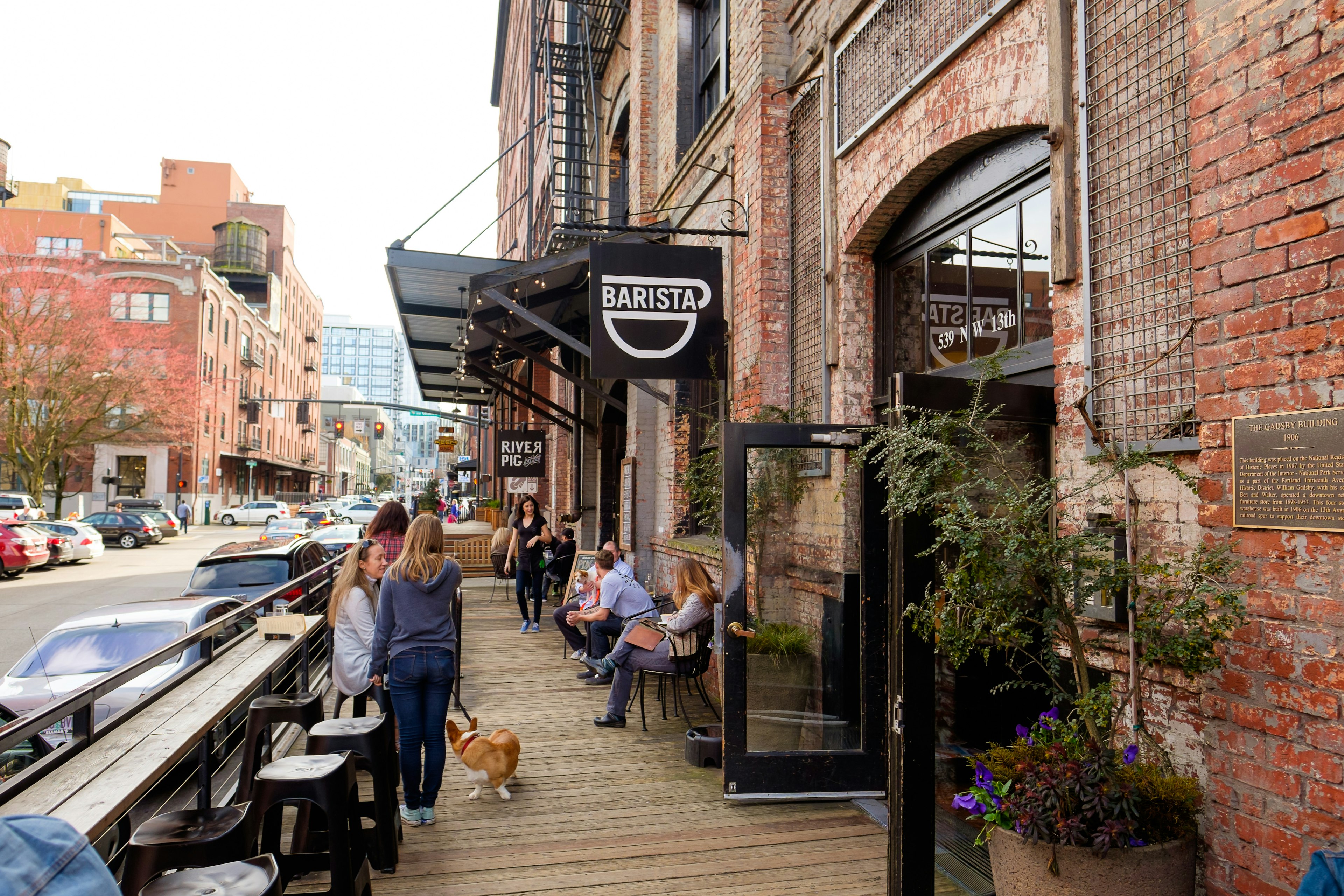 Customers and a corgi outside Barista coffee shop in Portland's Pearl District on a clear day