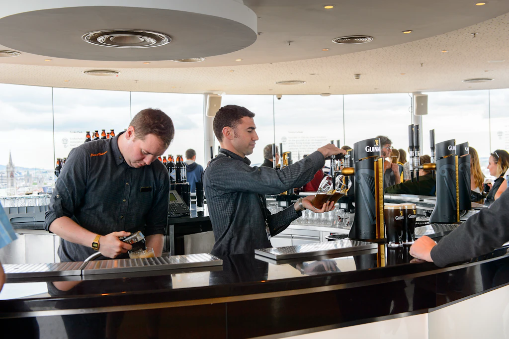 Unidentified man makes a pint of Guinness at the museum in Dublin