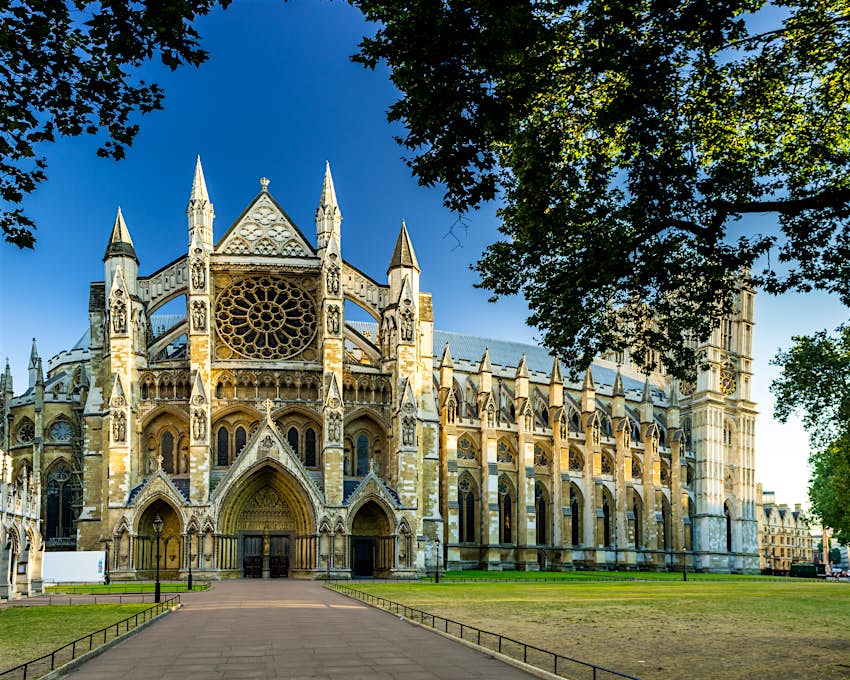 Westminster Abbey in London Exterior shot of a grand abbey building surrounded by green lawns