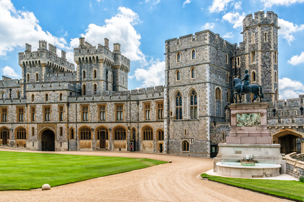 Exterior of a medieval castle with manicured green lawns