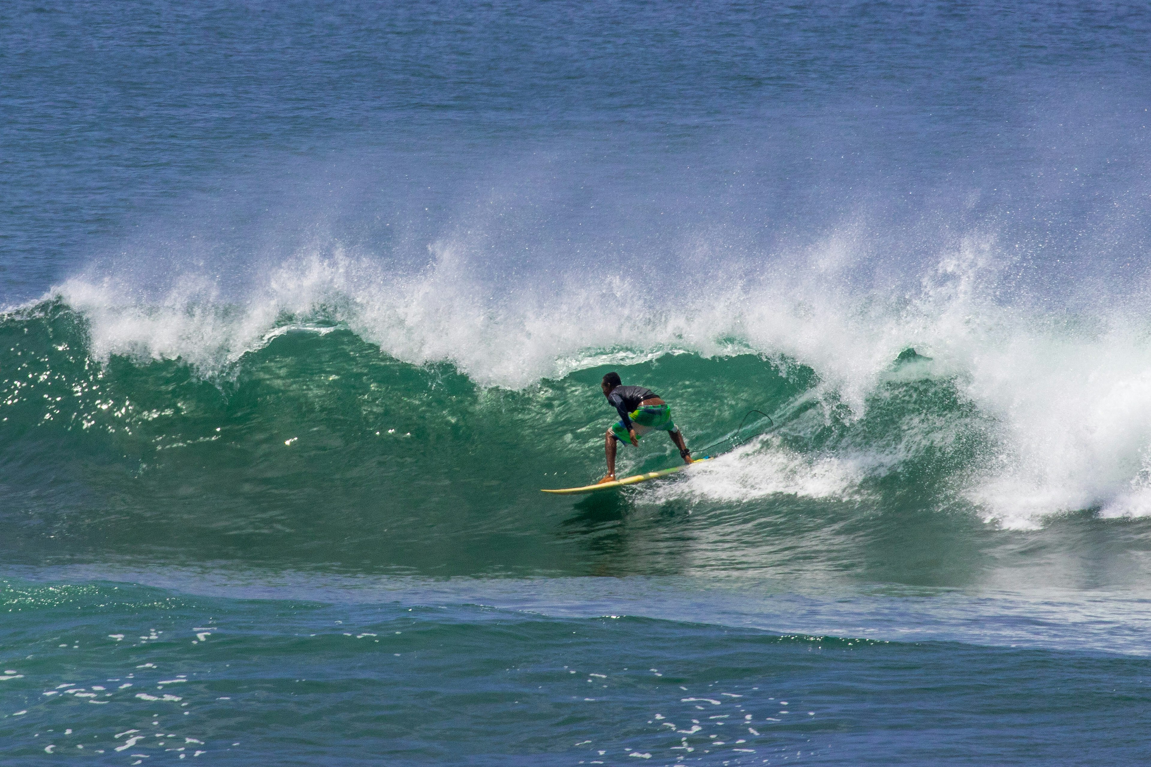 A surfer trying to get barreled on a big wave in Santa Catalina, Panama.