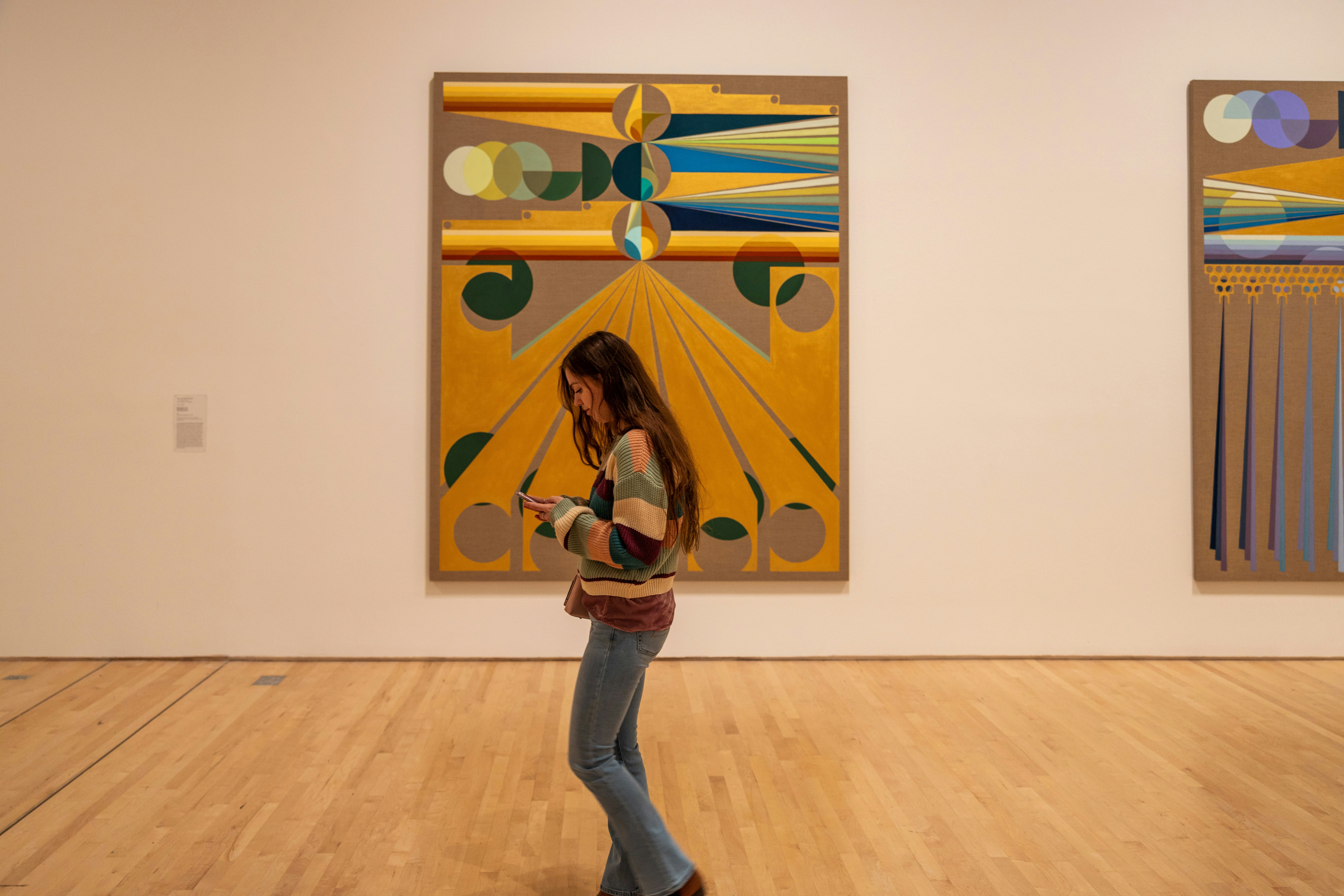 SAN FRANCISCO, USA - December 8, 2019, visitors are similar in color to the artifacts in question at the California Museum of Modern Art, a girl walks past the picture.; Shutterstock ID 1622086819; your: Meghan O'Dea; gl: 65050; netsuite: Online Editorial; full: POI page