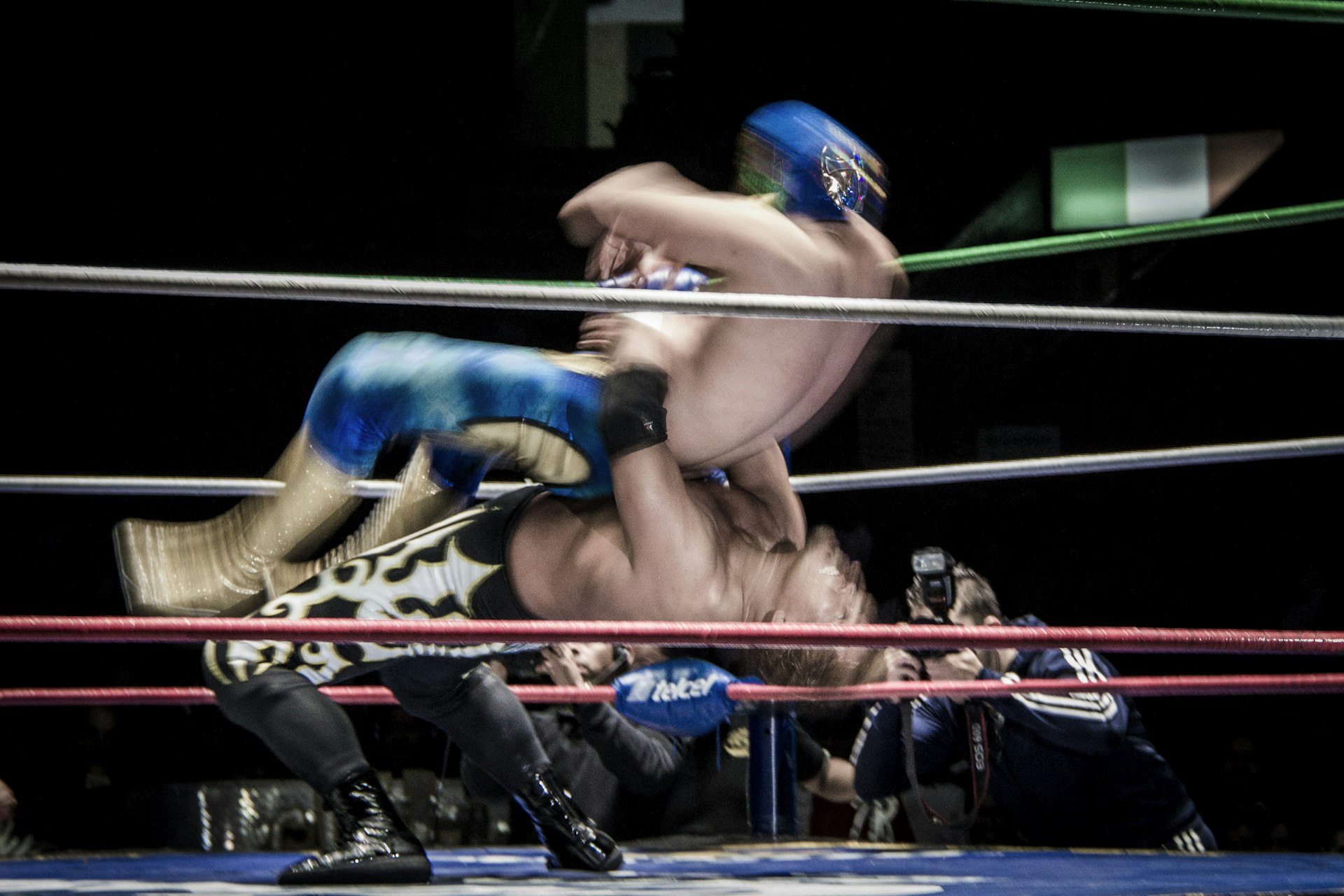 Mexican wrestlers tackle each other in the ring
