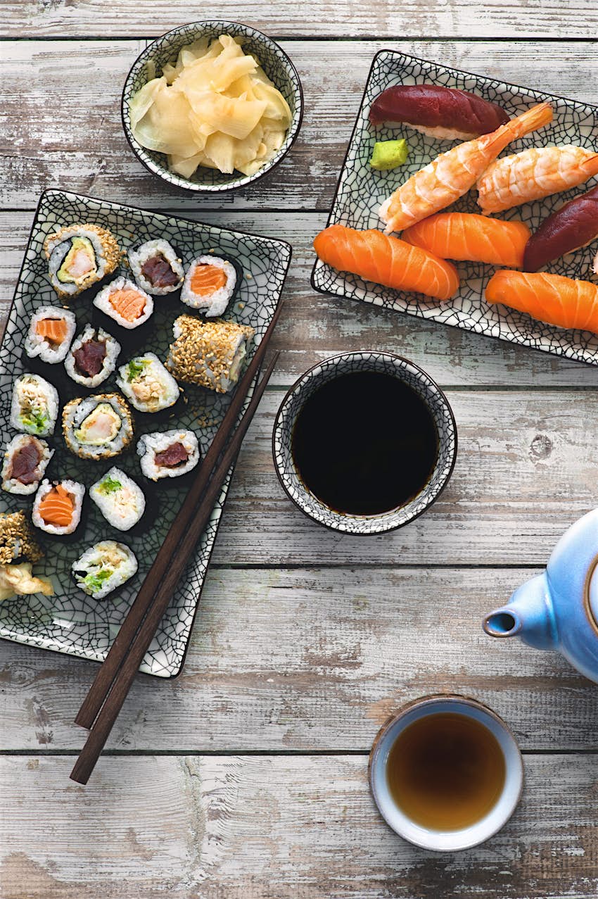 Japanese cuisine A shot of impeccably prepared Japanese dishes, including fish, sushi, cabbage, soup and tea