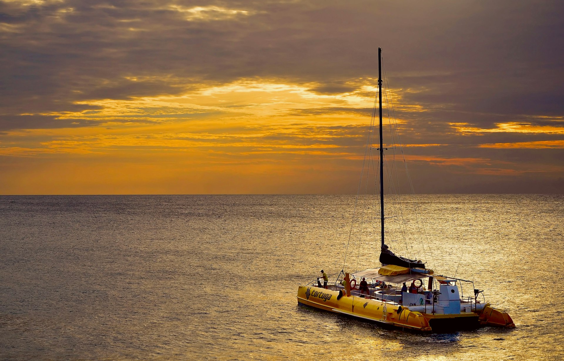 A boat heads out to Ricks Cafe in Negril at sunset in Negril 