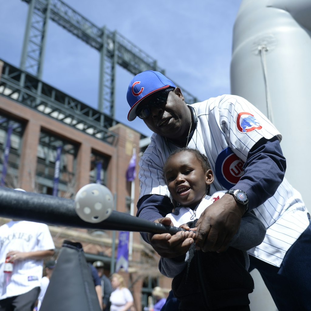DENVER, CO - APRIL 10: Gha'zruii Weber, 3, hits a ball with the help of his grandfather Thomas Weber outside the stadium before the game. The Colorado Rockies played the Chicago Cubs on opening day, April 10, 2015 at Coors Field in Denver, Colorado.(Photo by Brent Lewis/The Denver Post via Getty Images)