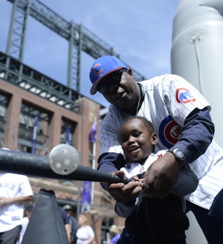 DENVER, CO - APRIL 10: Gha'zruii Weber, 3, hits a ball with the help of his grandfather Thomas Weber outside the stadium before the game. The Colorado Rockies played the Chicago Cubs on opening day, April 10, 2015 at Coors Field in Denver, Colorado.(Photo by Brent Lewis/The Denver Post via Getty Images)