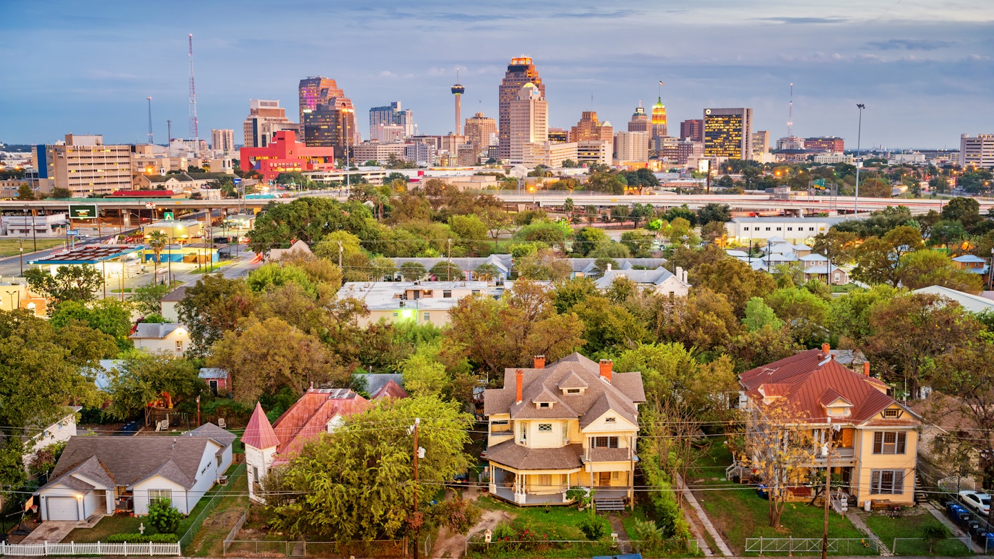 Stock photograph of a residential district and the downtown skyline of San Antonio Texas USA at twilight.