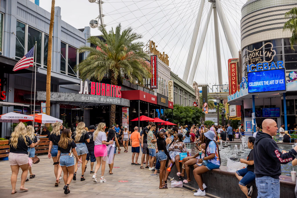 Pedestrians walk along the LINQ Promenade shopping area in Las Vegas, Nevada in front of a restaurant called Jaburritos