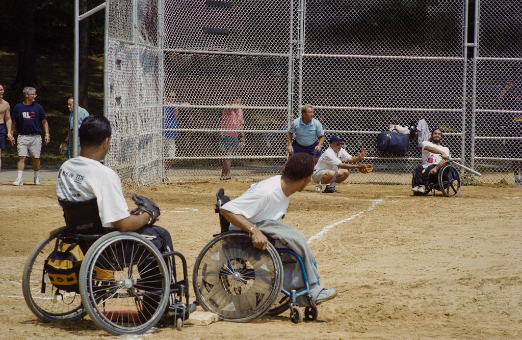 Disabled People In Wheelchairs Play Softball At The Annual Easter Seal Softball Classic