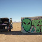 ALAMO, NEVADA - JANUARY 24: 'Vanlifer' Mary Alice Sandberg poses for a photo in a converted Sprinter Campervan next to Area 51 graffiti on January 24, 2021 in Alamo, Nevada. (Photo by Josh Brasted/Getty Images)