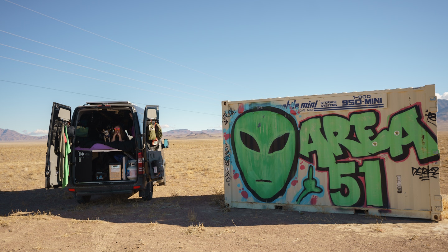 ALAMO, NEVADA - JANUARY 24: 'Vanlifer' Mary Alice Sandberg poses for a photo in a converted Sprinter Campervan next to Area 51 graffiti on January 24, 2021 in Alamo, Nevada. (Photo by Josh Brasted/Getty Images)