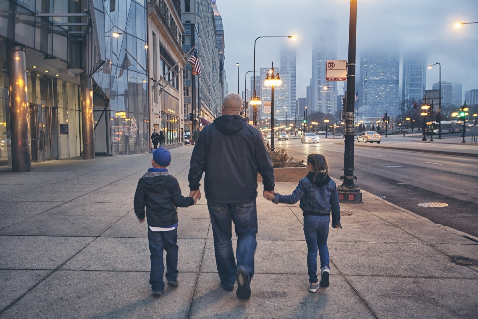 A father and two kids walk down Michigan Avenue in Chicago, Illinois, Midwest, USA