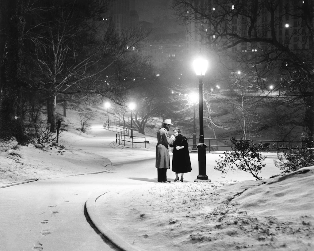 A couple pauses for a cigarette in snowy Central Park. A couple pauses for a cigarette in snowy Central Park.