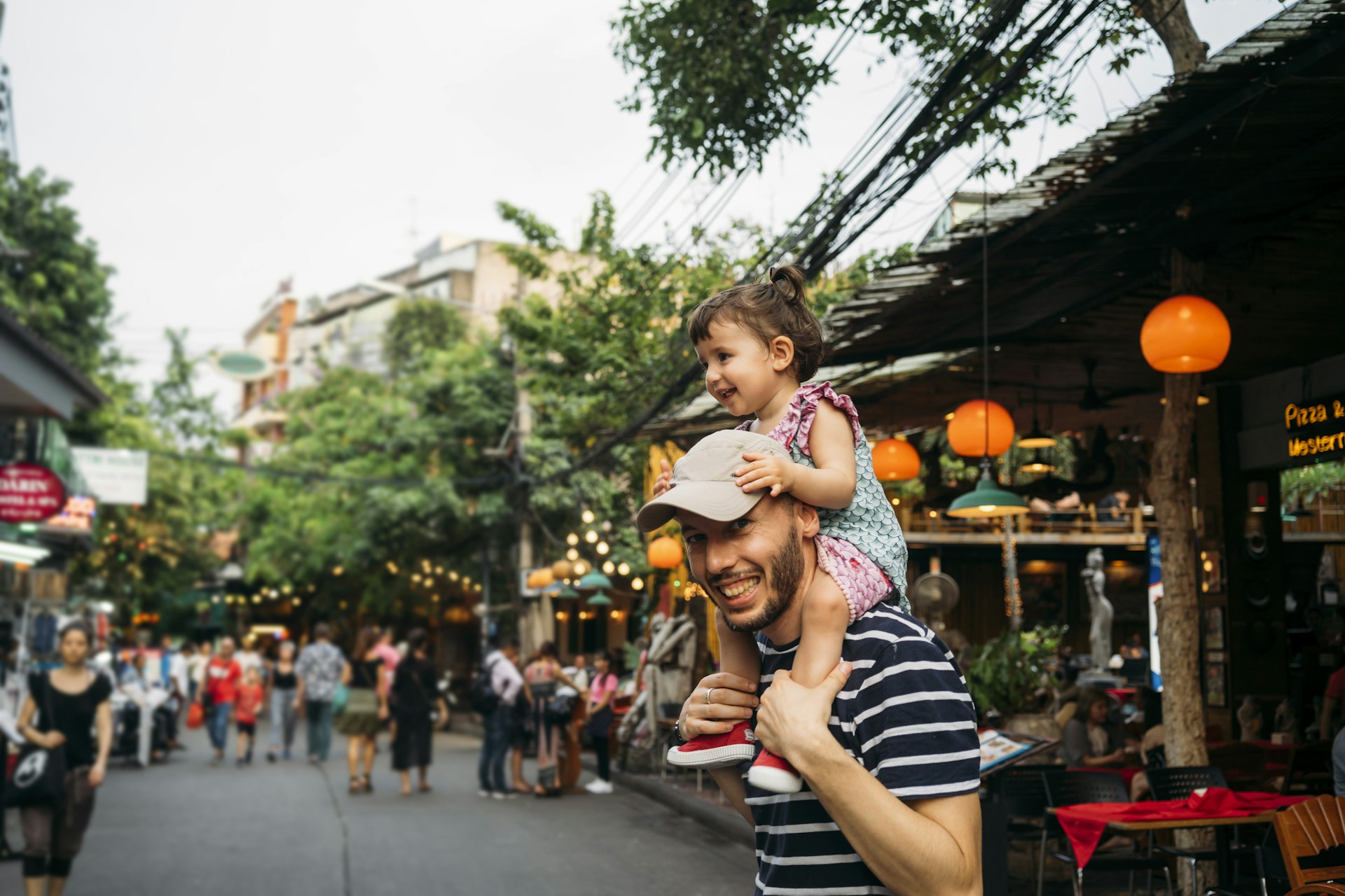 Thailand, Bangkok, portrait of smiling father and daughter on Khao San Road