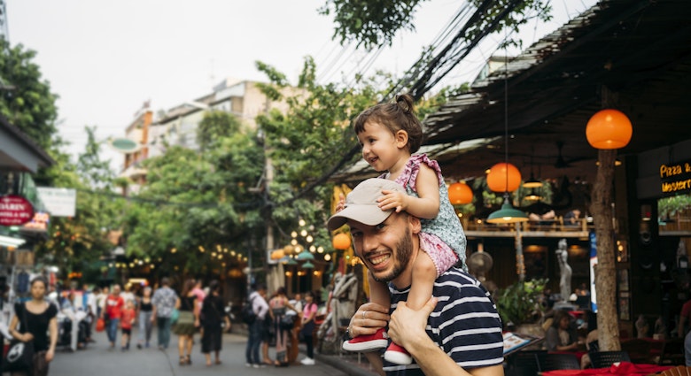 Thailand, Bangkok, portrait of smiling father and daughter on Khao San Road.