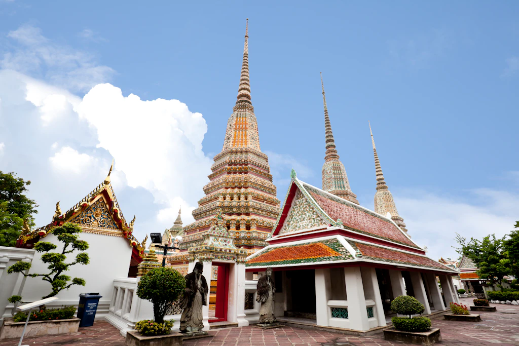 Wat Pho The golden stupas of Wat Pho sit quiet and in peace against the piercing blue skies of Bangkok, Thailand