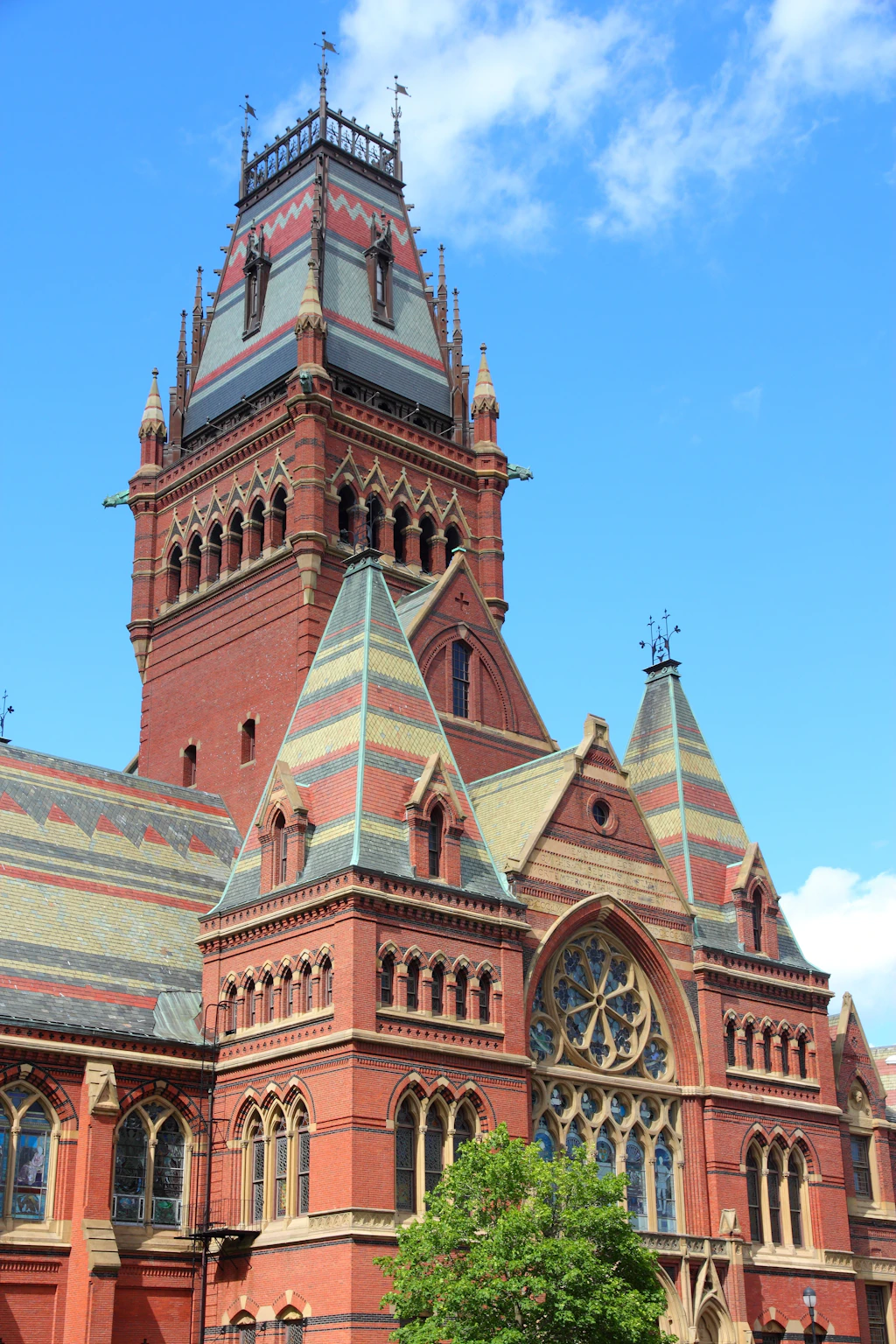 A red-brick Gothic building with a tall central tower
