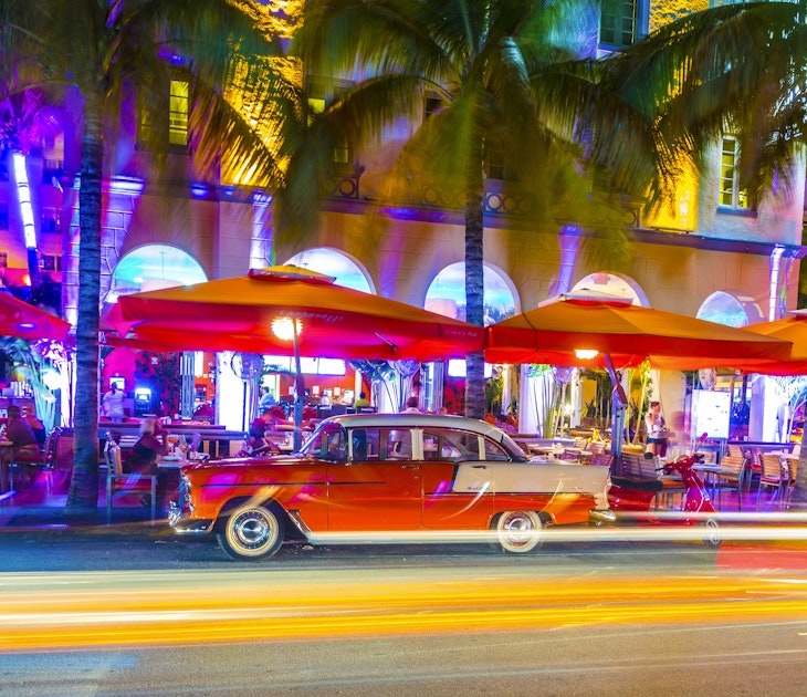 Miam, United States - July 31, 2013: Night view at Ocean drive  in Miami Beach, Florida. Old vintage cars park in the Art Deco district,the main tourist attraction in Miami.