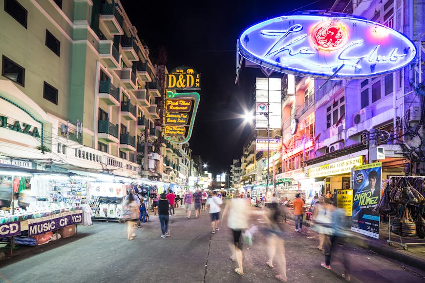 People, captured with blurred motion, walk at night along Khao San Road in Bangkok. This area is very popular with backpackers and other travelers. 