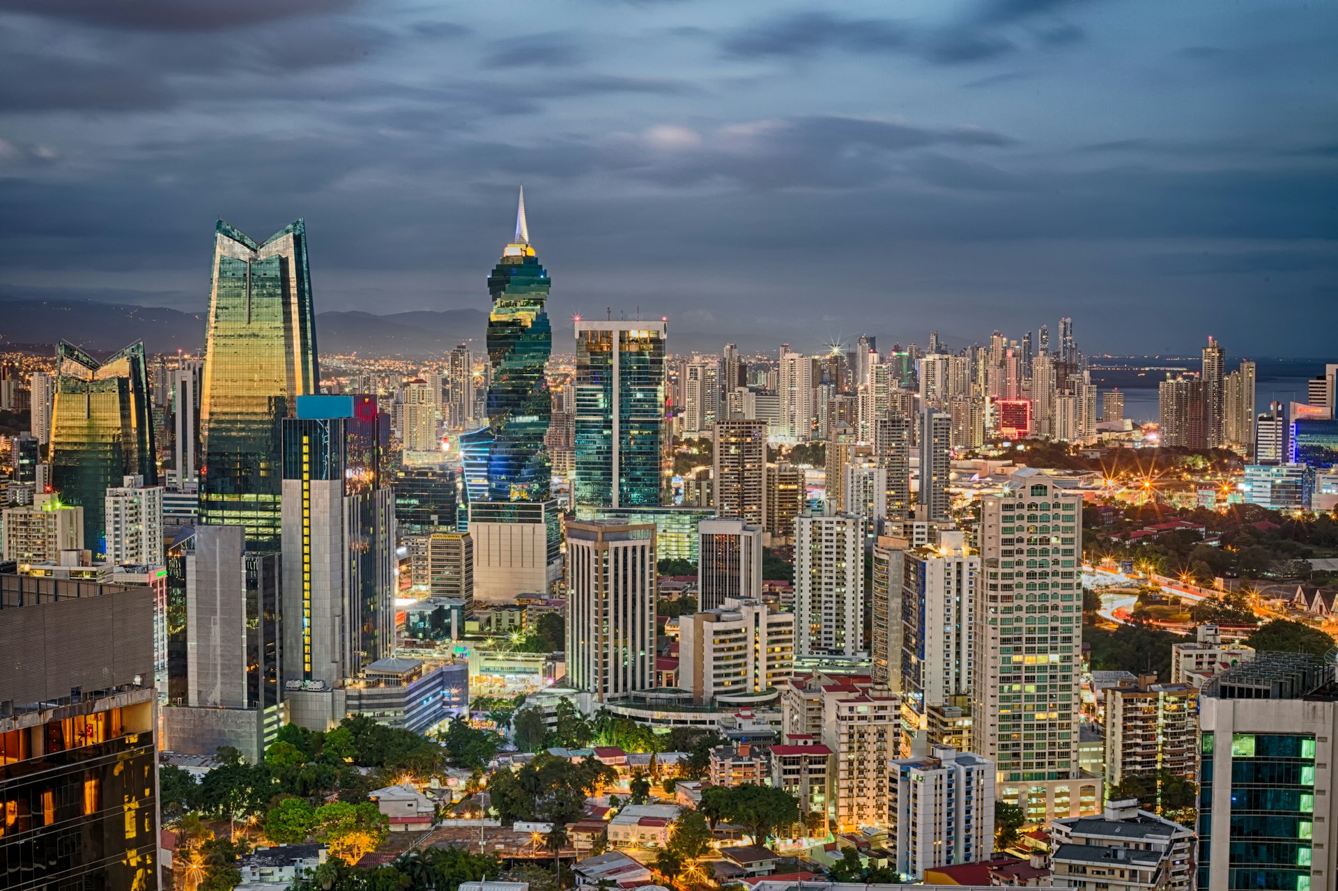 Skyscrapers rise over Panama City backed by an ominous dark sky of rain clouds