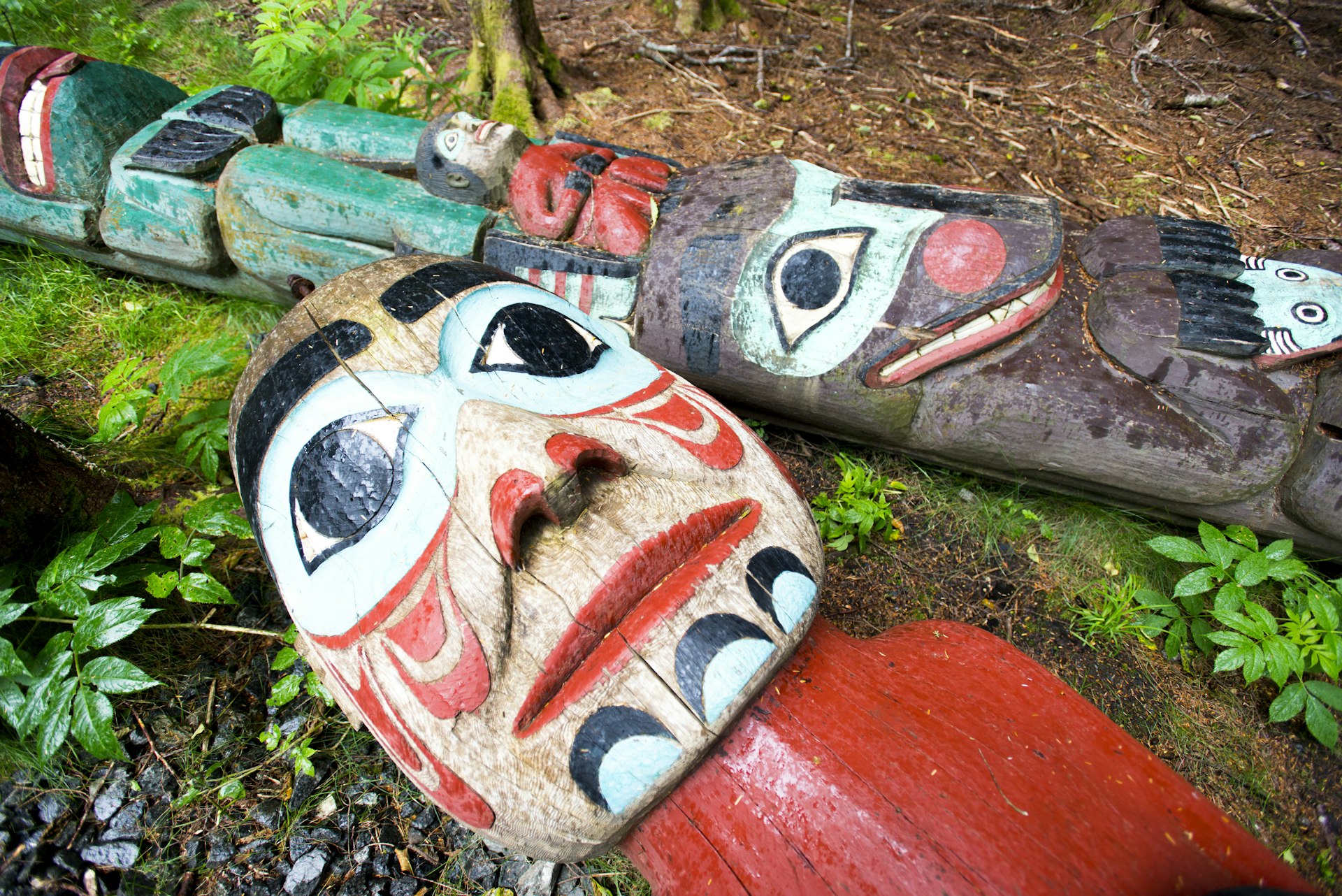 Totem poles laying on the ground