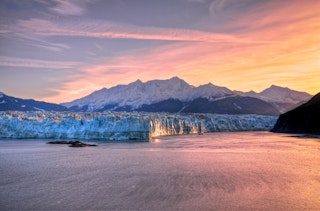 Sunrise at Hubbard Glacier with mountain in Alaska.