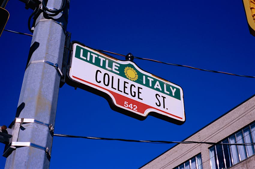 Reading a street sign "Little Italy"