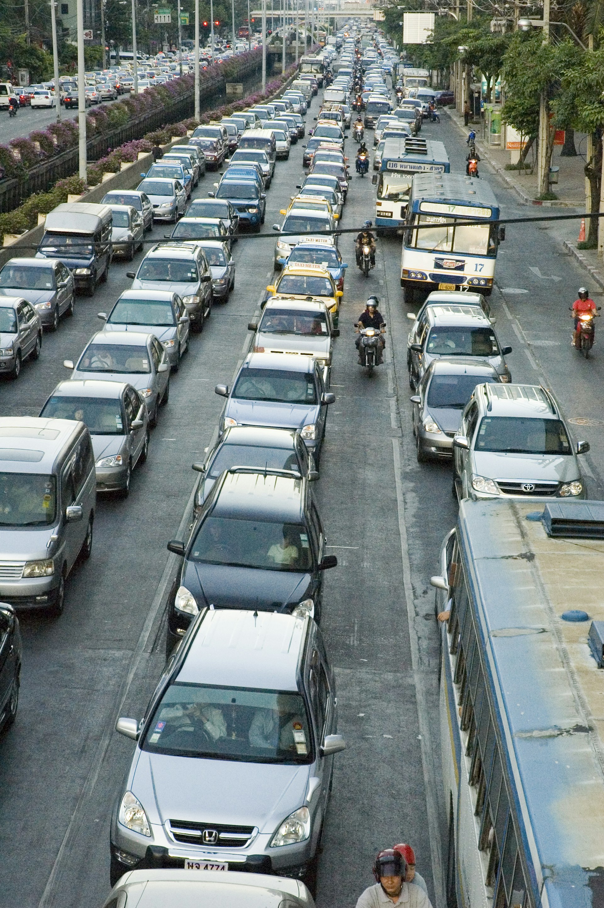 Stationary Bangkok traffic on Th Sathorn with scores of grey cars at a standstill.