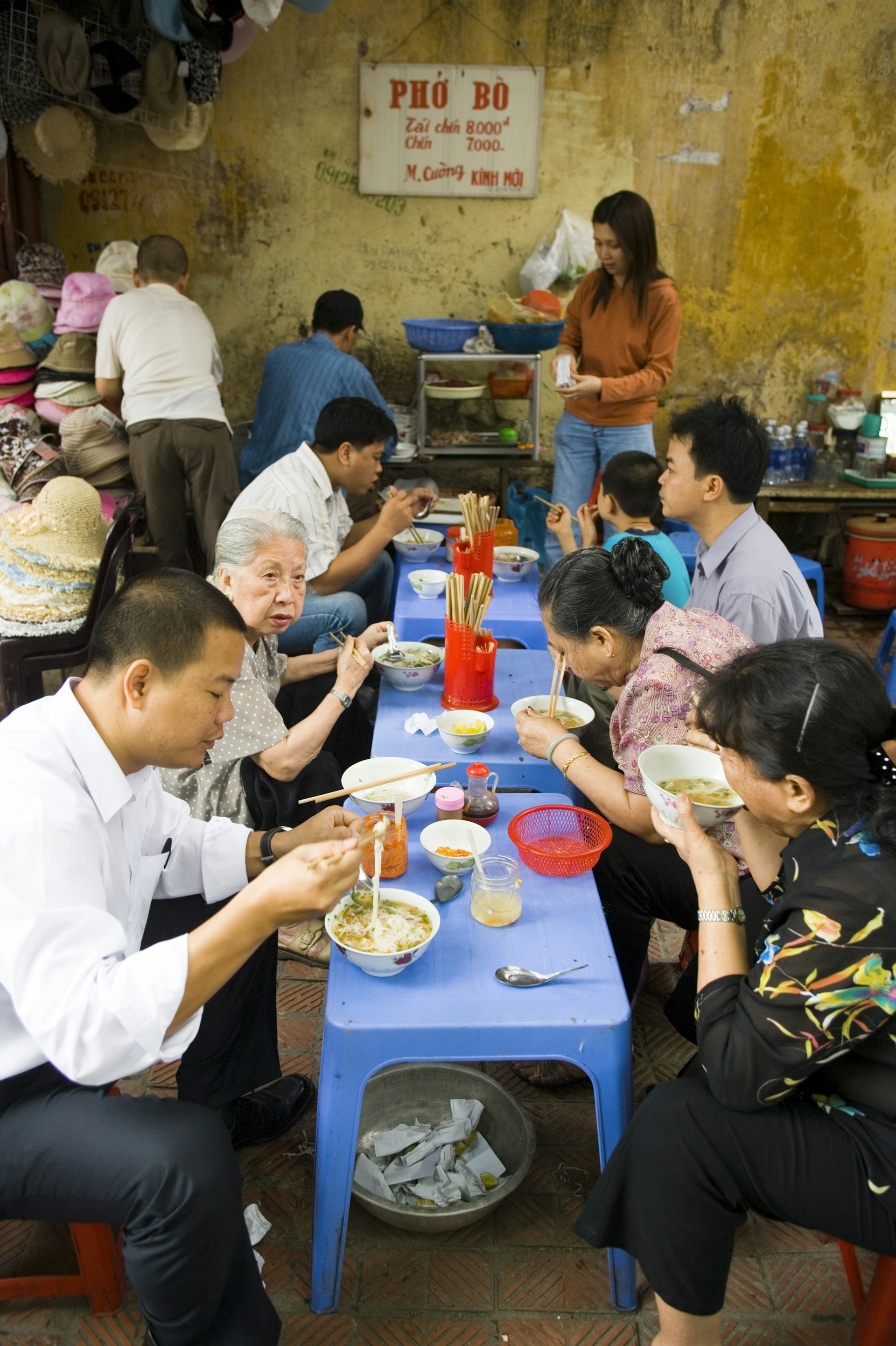 People dining at street food stall, Old Quarter, Hanoi.