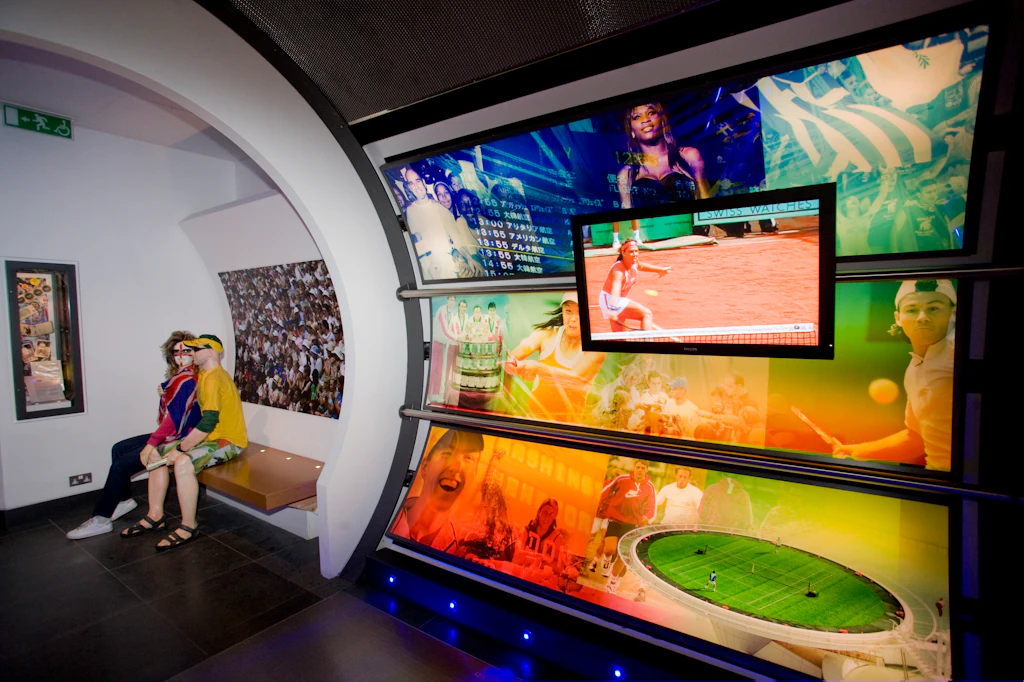 LPI-26402-48.jpg A view of the inside of the Wimbledon Lawn Tennis Museum, showing exhibitions and photographs lit up on the walls.