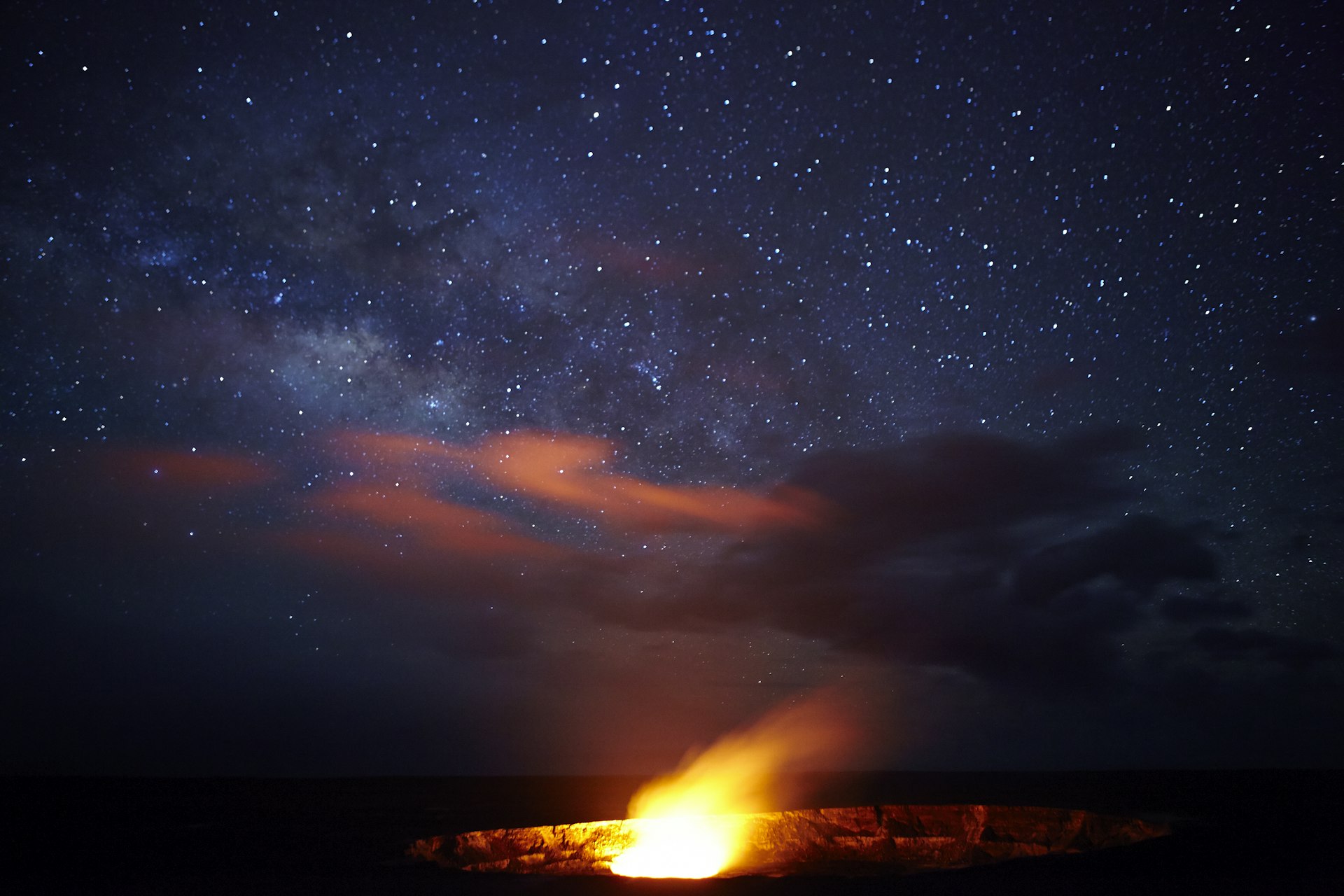 A volcano caldera under the Milky Way at night