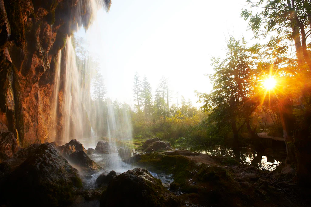 Waterfall, Plitvice National Park A shot taken from behind a waterfall towards the sun