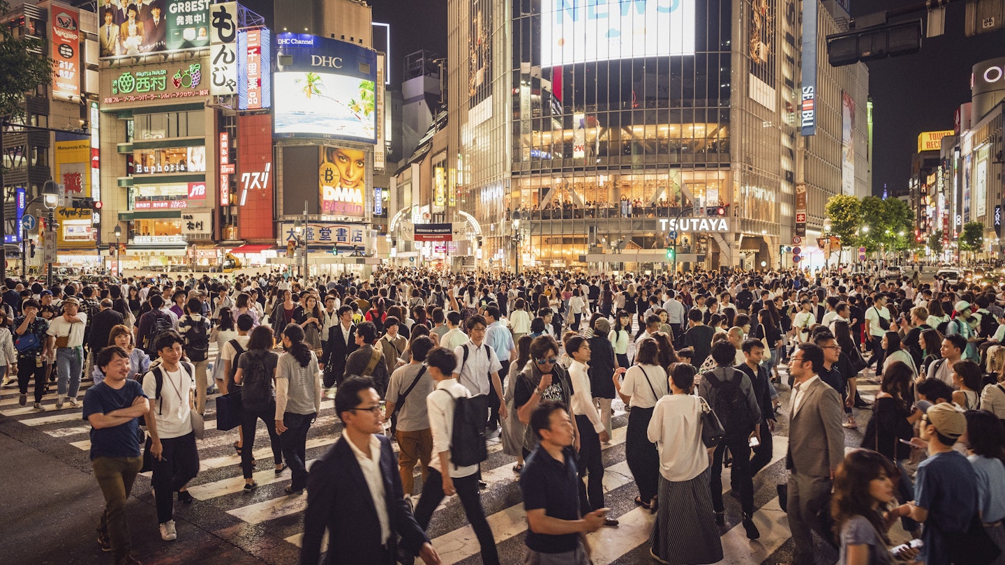 Crowds of people on Shinjuku Crossing.